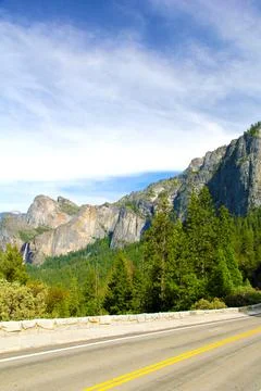 Route between the mountains, with a cloudy sky in the background, sunny day Stock Photos