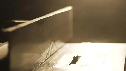 Router table in hazy backlight as a board is fed through Stock Footage 346255720