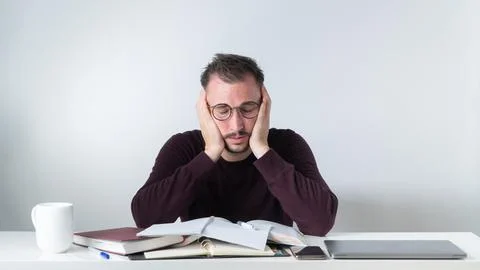Routine and a lot of tasks at work - a male employee solves complex work tasks Stock Photos