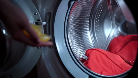 Routine hygiene concept, process of loading electric washing machine before Stock-Footage 146194213