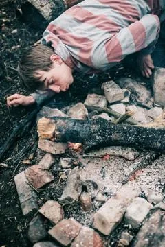 Rover blowing into campfire. High angle view. Stock Photos