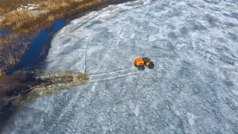 The rover climbs up on thin ice out of the water. Conquering the Arctic with Stock Footage 262627703