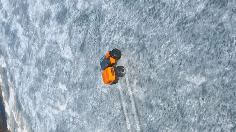 The rover climbs up on thin ice out of the water. Conquering the Arctic with Stock Footage 263076691