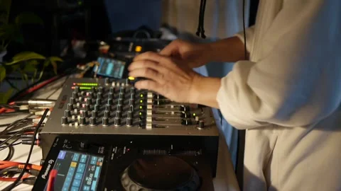 Roving camera films hands of person in white sweater making adjustments to Stock Footage 171111900