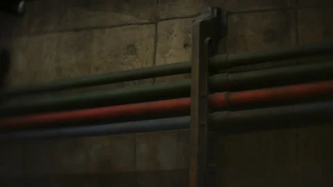 Row Aligned Pipes on Concrete Corridor Wall with Ceiling Lights and Perspective Stock Footage 334821351