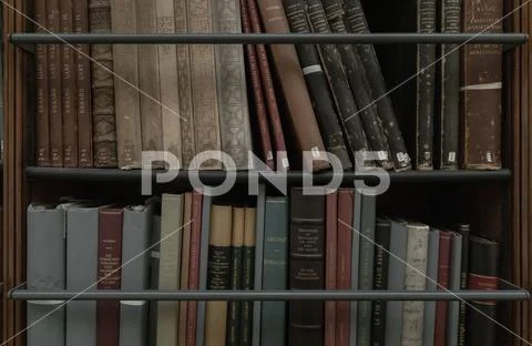 Row of Antique books on wooden shelves in library. ~ Premium Photo ...