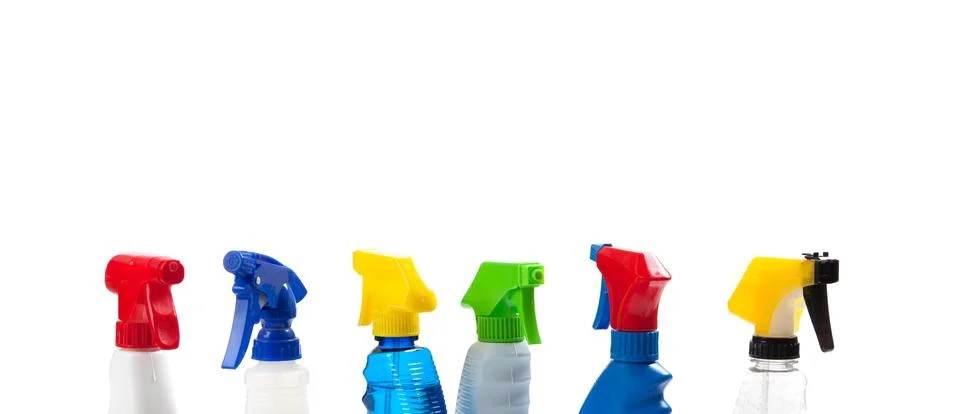 A row of assorted cleaning trigger bottles with copy space Stock Photos