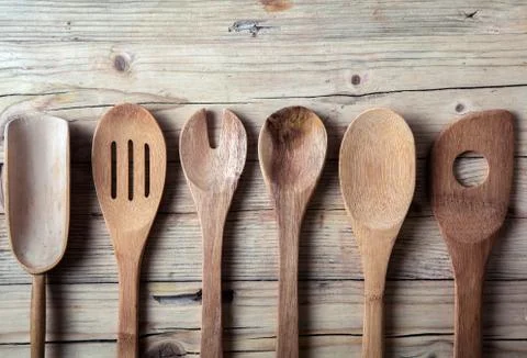 Row of assorted old wooden kitchen utensils Stock Photos