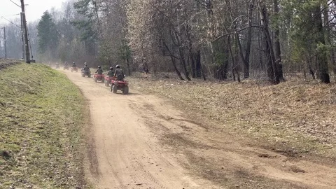 A row of ATV going on forest road Stock Footage 127305713