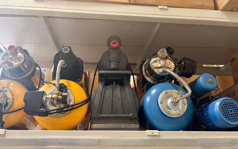 Row of automatic water pumping stations and equipment on display shelves in.. Stock Photos