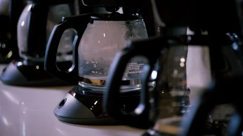 Row of basic drip brew coffee makers for large corporate office kitchen Video stock 112936278