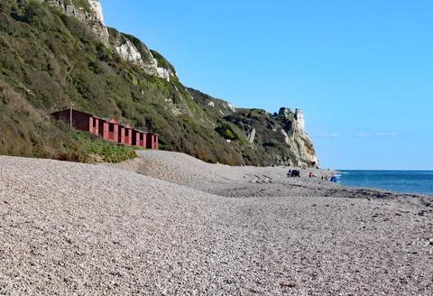A row of beach huts on the shingle beach at Branscome in Devon, England. Stock-Fotos