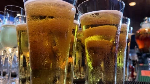 Row of beerfilled glasses on bar counter Drinkware, Liquid, Barware Video stock 268434652