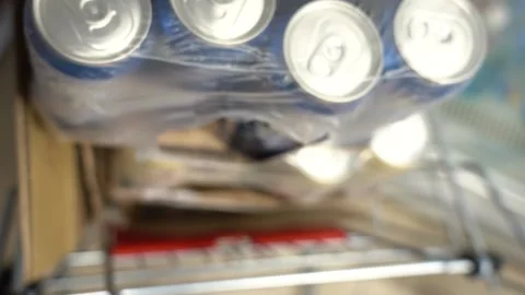 A row of beverage cans in a trolley. Unpacked beverage cans 動画素材 156809266