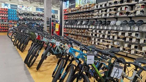 Row of bicycles displayed inside sporting goods store Stock Photos