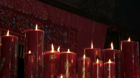 Row of big burning red candles inside the Chinese temple Stock Footage 134178169