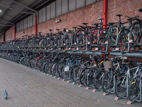 Row of bikes locked securely, a full cycle rack on a train platform Stock Photos