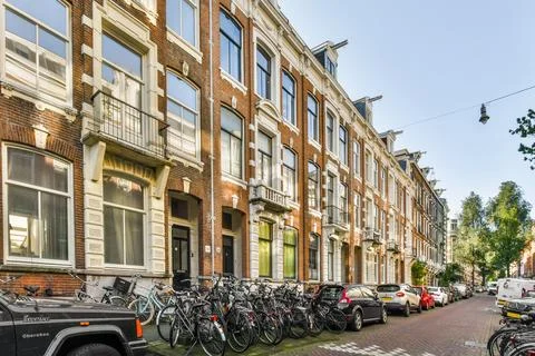 A row of bikes parked in front of a building Stock Photos