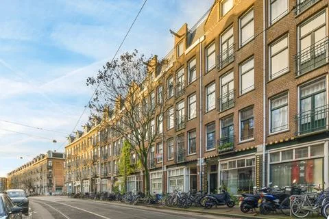 A row of bikes parked in front of a building Fotos de archivo