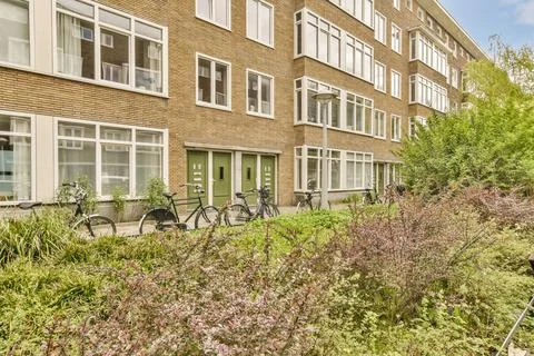 A row of bikes parked outside of a brick building Fotos de archivo