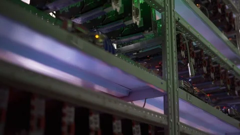 Row of bitcoin miners set up on the wired shelfs. Video stock 94762234