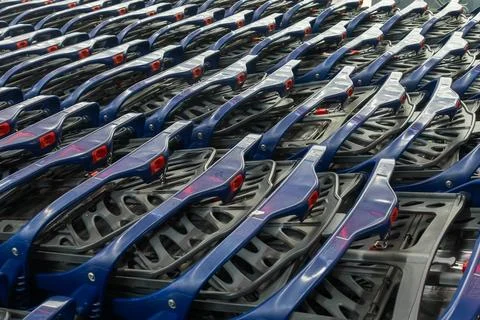 Row of blue plastic shopping carts in a store. Perspective view of empty sh.. Stock Photos