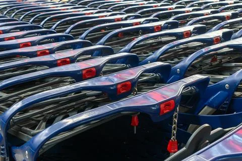 Row of blue plastic shopping carts in a store. Perspective view of empty sh.. Stock Photos