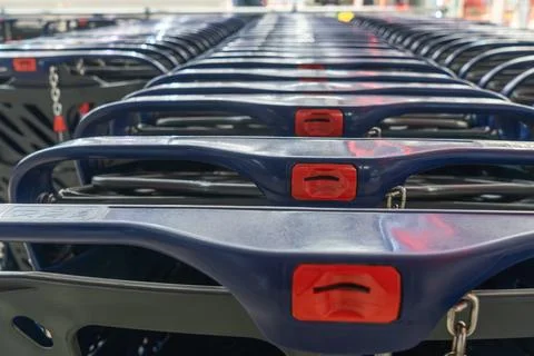 Row of blue plastic shopping carts in a store. Perspective view of empty sh.. Stock Photos