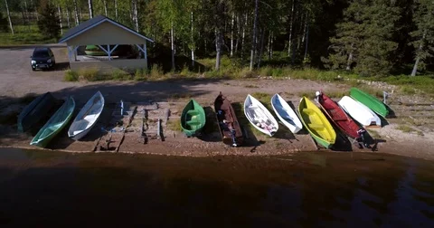Row boats at a beach, Cinema 4k aerial sideway view of a coast full of boats  Stock Footage 80472953