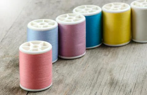 Row of bobbins with thread Stock Photos