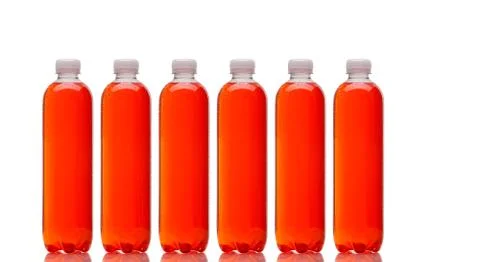 Row of bottles with orange beverage Stock Photos
