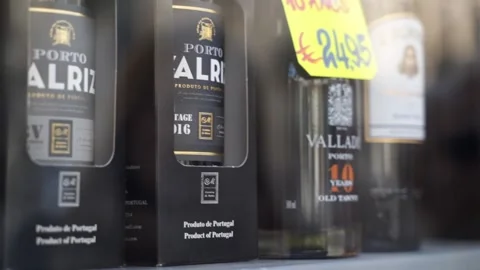 Row of bottles of Port wine on window display, in Porto, Portugal, Close Up Pan Stock Footage 131773268
