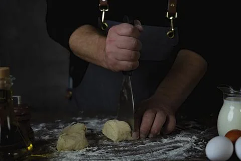 Row bread dough divided by man or pastry chef or baker. Stock Photos