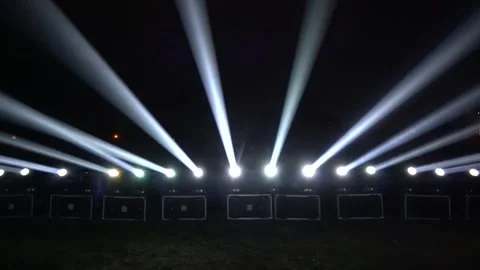 Row of Bright Spotlights with Vertical Light Rays in the Dark Видео 334040185
