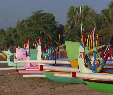 Row of brightly colored boats lined up on the sand Stock Footage 86747837