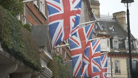 A row of British flags hanging off old buildings. Video stock 123227312
