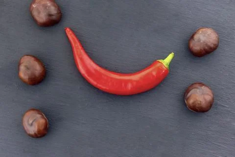 Row brown fruit chestnut culinary set frame pod red red sharp curved on black Stock Photos
