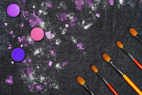Row of brushes and crashed eyeshadow Stock Photos