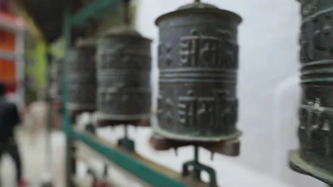 A row of buddhist prayer drums spin at Kathmandu street, rithual bless wheels Stock Footage 167490462
