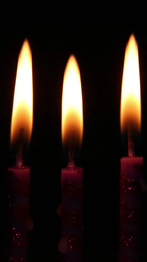Row of burning candles being extinguished one by one against black background Stock Footage 311012267
