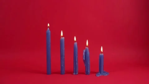 Row of Burning Red Candles in Different Stages of Melting Stock Footage 312739515