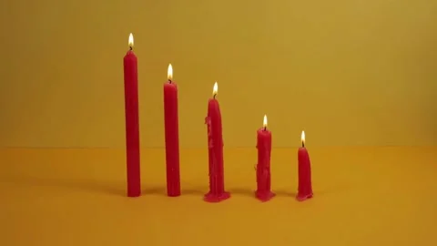 Row of Burning Red Candles in Different Stages of Melting Stock Footage 312739807