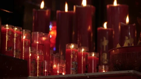 Row of burning red candles inside the Chinese temple Stock Footage 134178693
