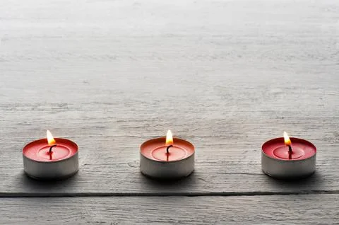 Row of burning red tealights Stock Photos
