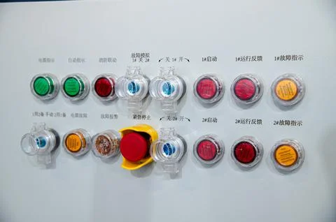 A row of buttons with a red button in the middle Stock Photos