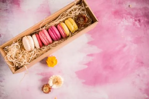 Row of cake macaroons in gift box on bright background. Copyspace for text and Stock Photos