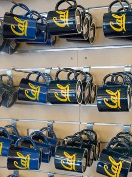 Row of Cal mugs inside school store Stock Photos