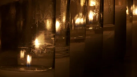 Row of candles burning with close up of flame, wax and glow of light 스톡 동영상 106832450