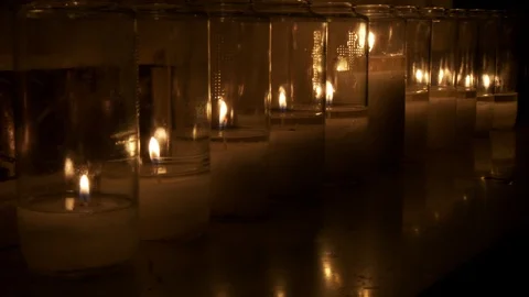 Row of candles burning with  flame and glow of light, interior church. 스톡 동영상 106832430
