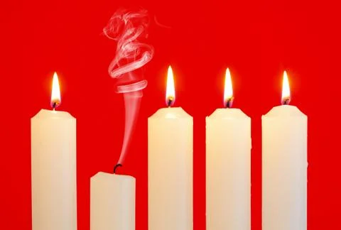 Row of candles with one extinguished Stock Photos